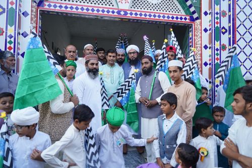 Free Group of people in traditional clothing holding flags during a cultural celebration. Stock Photo