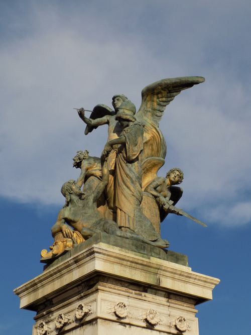 Free Sculptures atop the Altar of the Fatherland in Rome, Italy, against a clear sky. Stock Photo