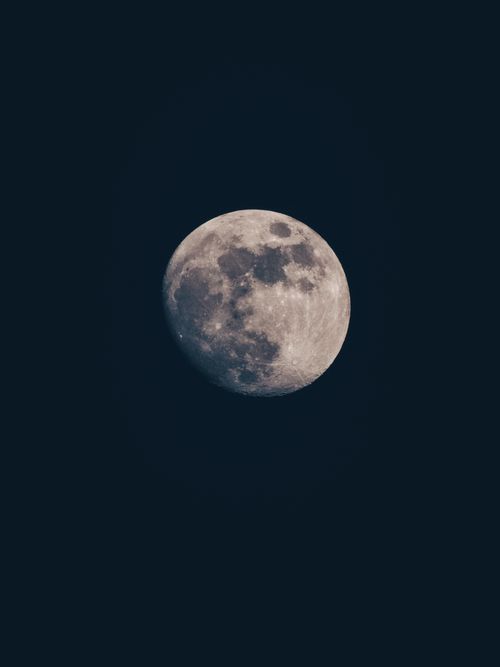 Free Capture of the full moon in clear detail against a dark night sky, showcasing lunar features. Stock Photo