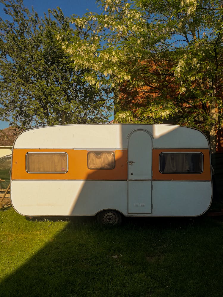 A Camper Trailer On Green Grass Field