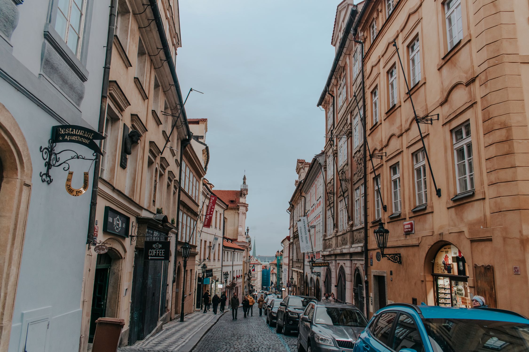 Explore the charm of a historic Prague street with classic architecture and cobblestones.