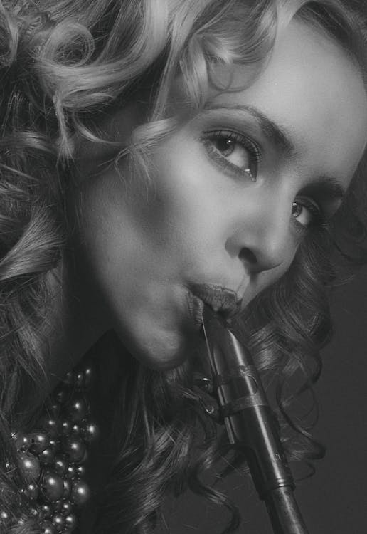 Portrait of Woman Playing on Flute in Black and White 