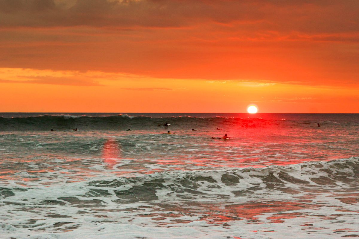 Surfers at sunset in Santa Teresa, Costa Rica