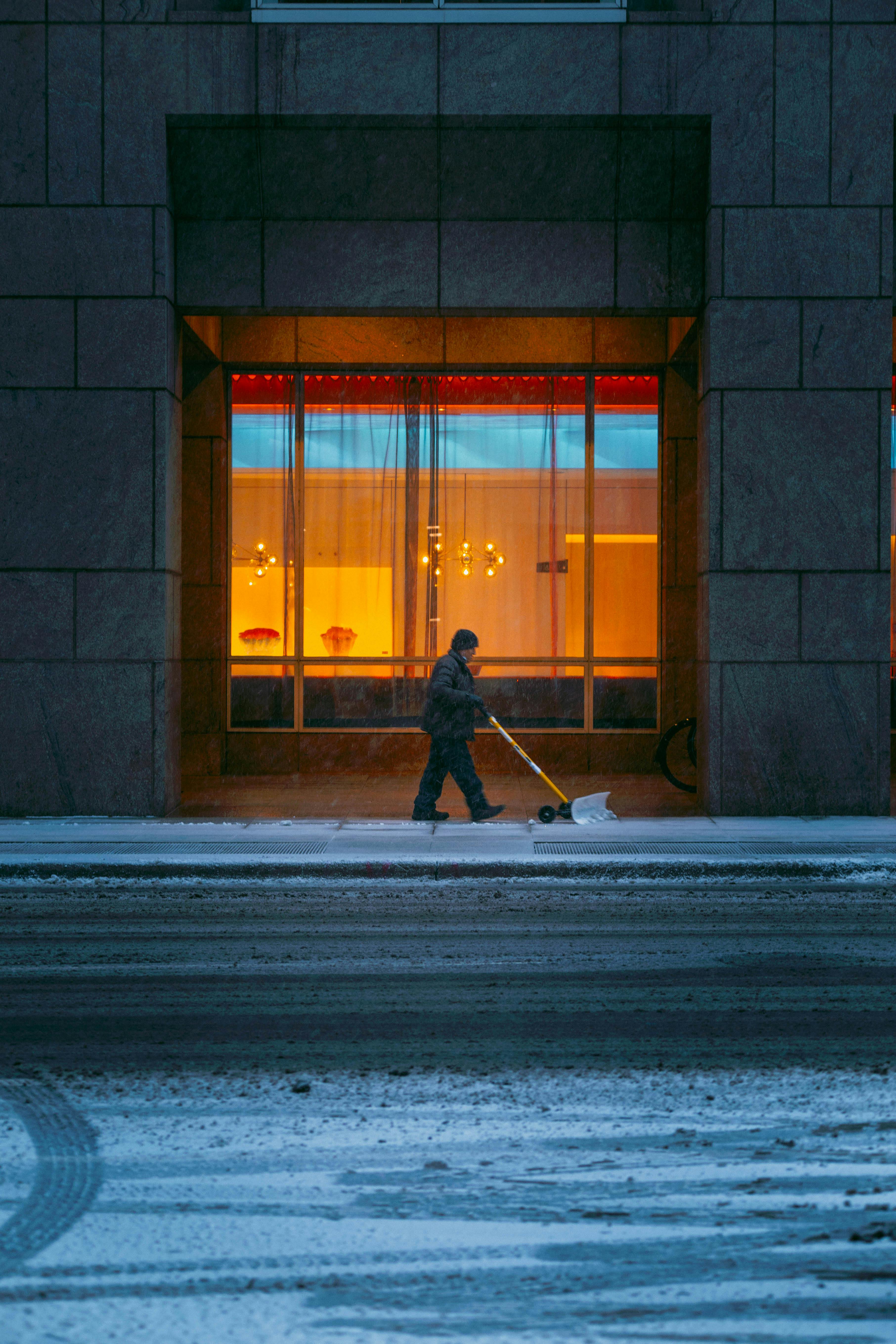 woman in black jacket walking on sidewalk