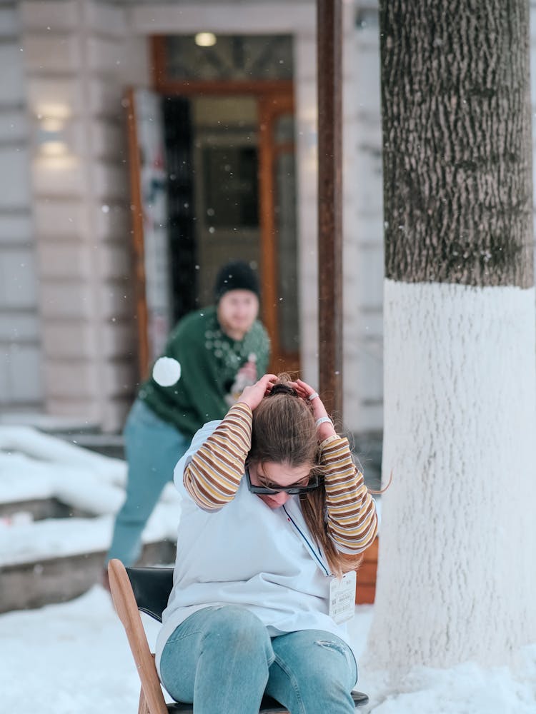 Woman And Man Playing Snowball Fight