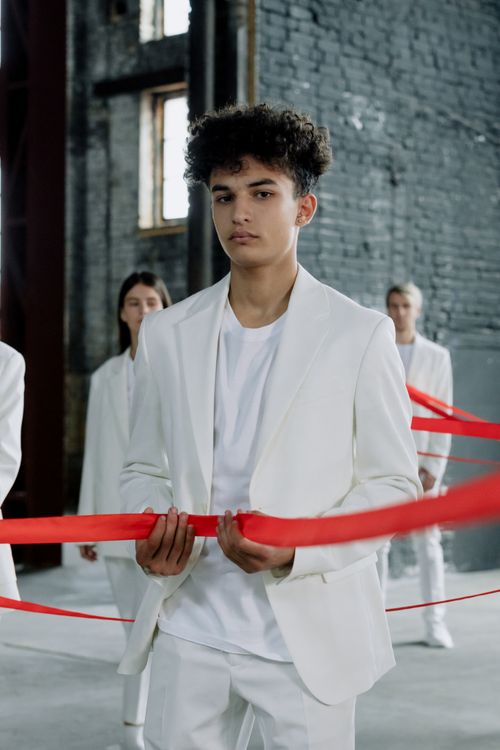 Man With Ribbon Man in White Suit Holding Red Ribbon · Free Stock Photo