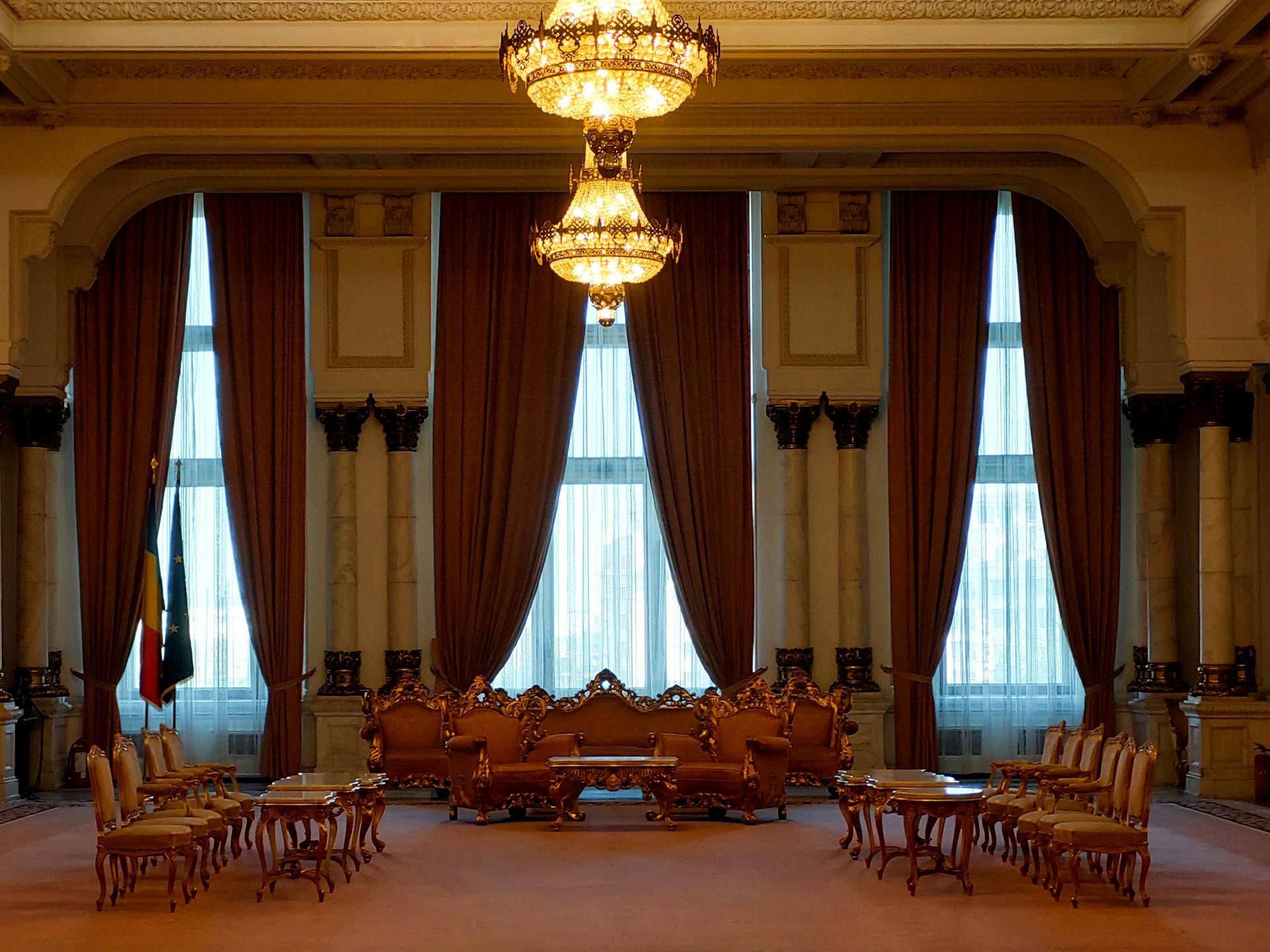 A grand and elegant room with luxurious chandeliers and classic furniture, exuding a regal atmosphere.