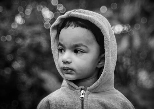 Grayscale Photo of a Boy Wearing Jacket