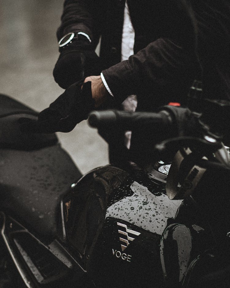 Man Putting On Gloves Before Motorbike Ride