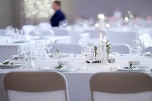 Free Candlelit white table settings at an elegant wedding reception, perfect for intimate events. Stock Photo