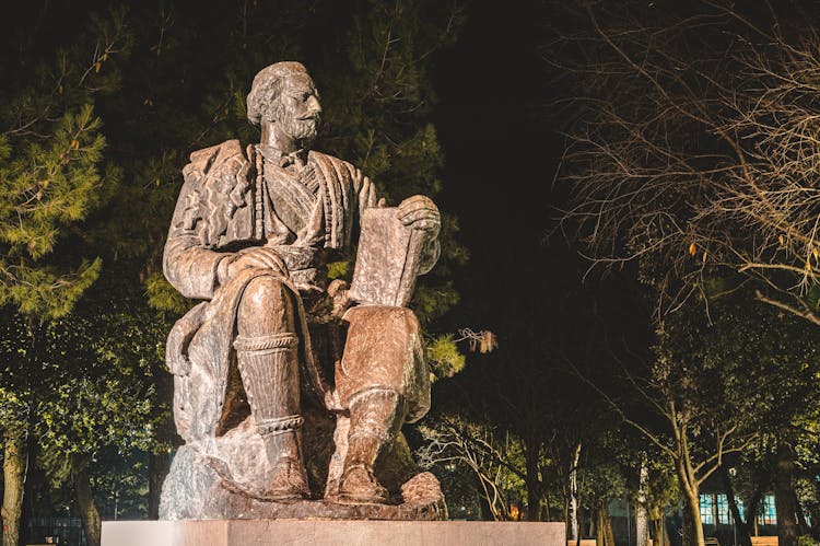 Statue Of Man With Book