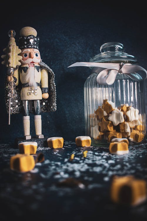 Free Nutcracker beside a Glass Container of Candies  Stock Photo