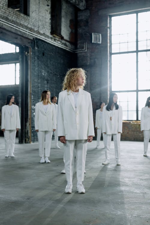 Women Wearing White Suits in a Studio