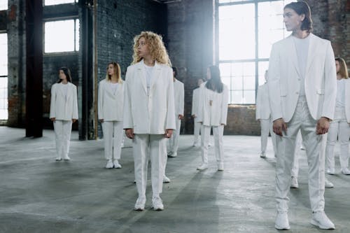 A Group of People in White Clothes Looking Over Shoulder