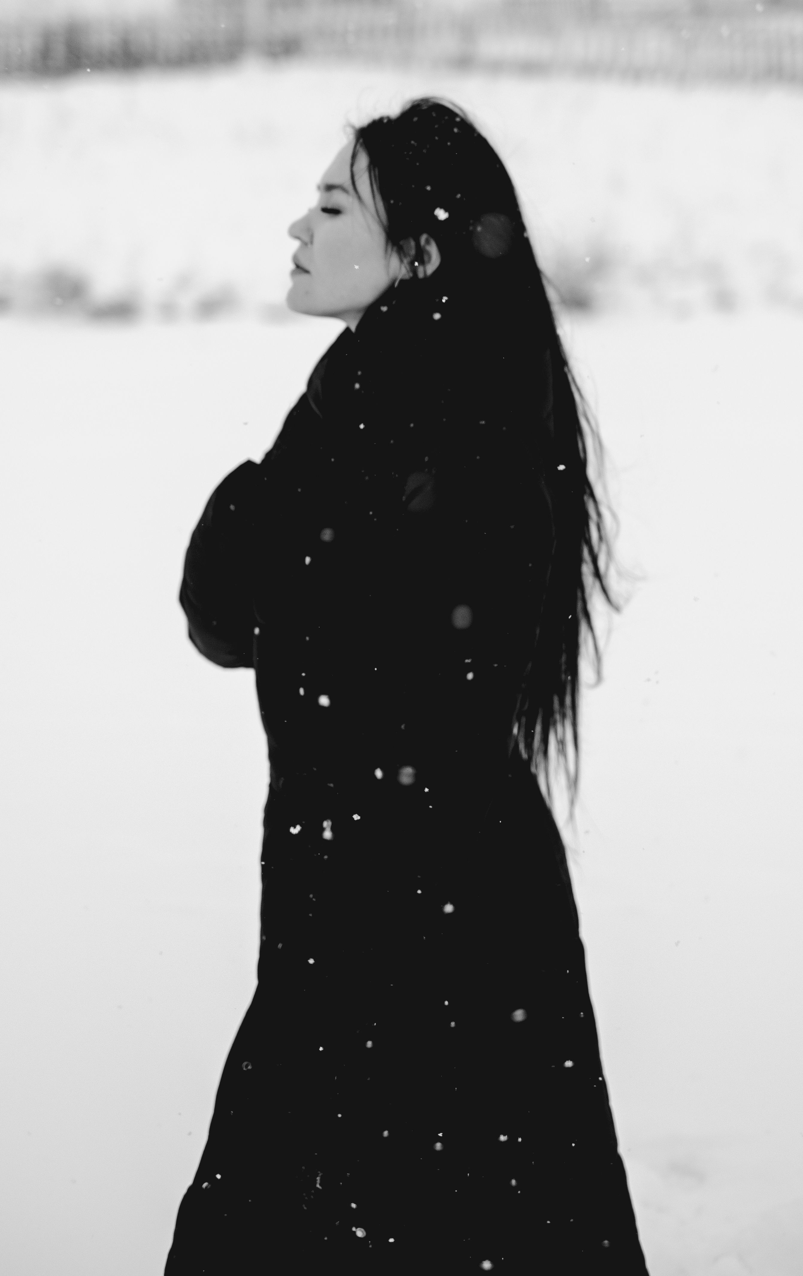 Black and white portrait of a woman in winter clothing in snowy Bashkortostan.