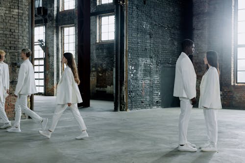 Two People in White clothing looking at each other 