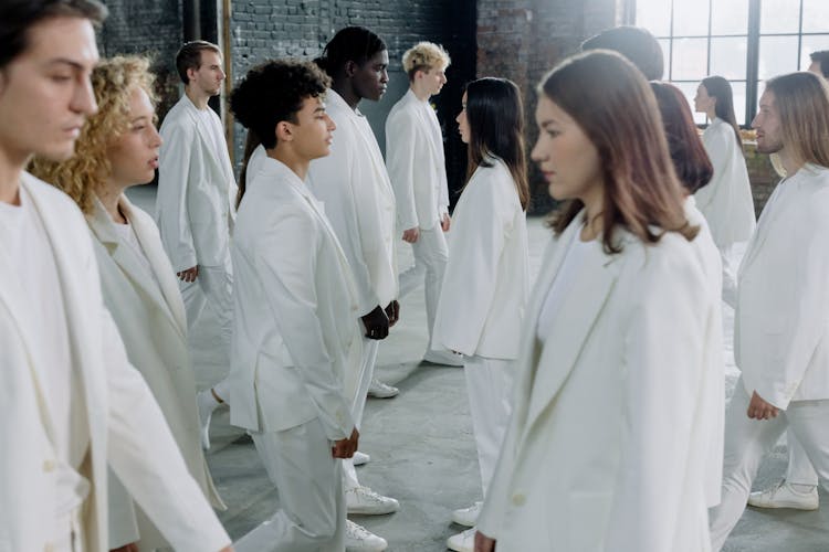 People In White Outfit Standing Face To Face