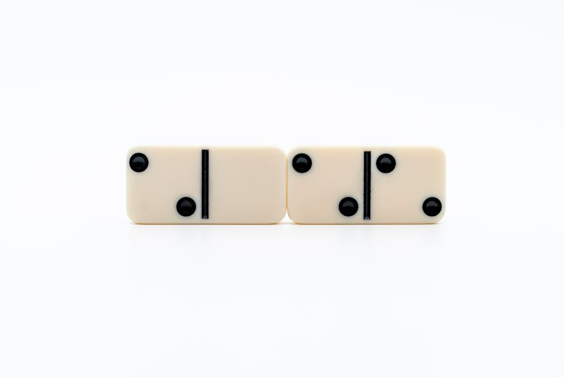 2 Brown Wooden Dice on White Surface