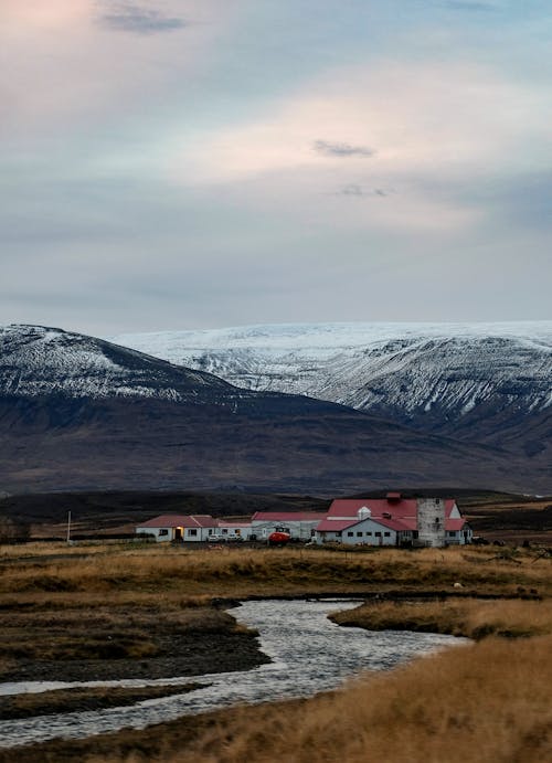 Farm Buildings near River in Mountains