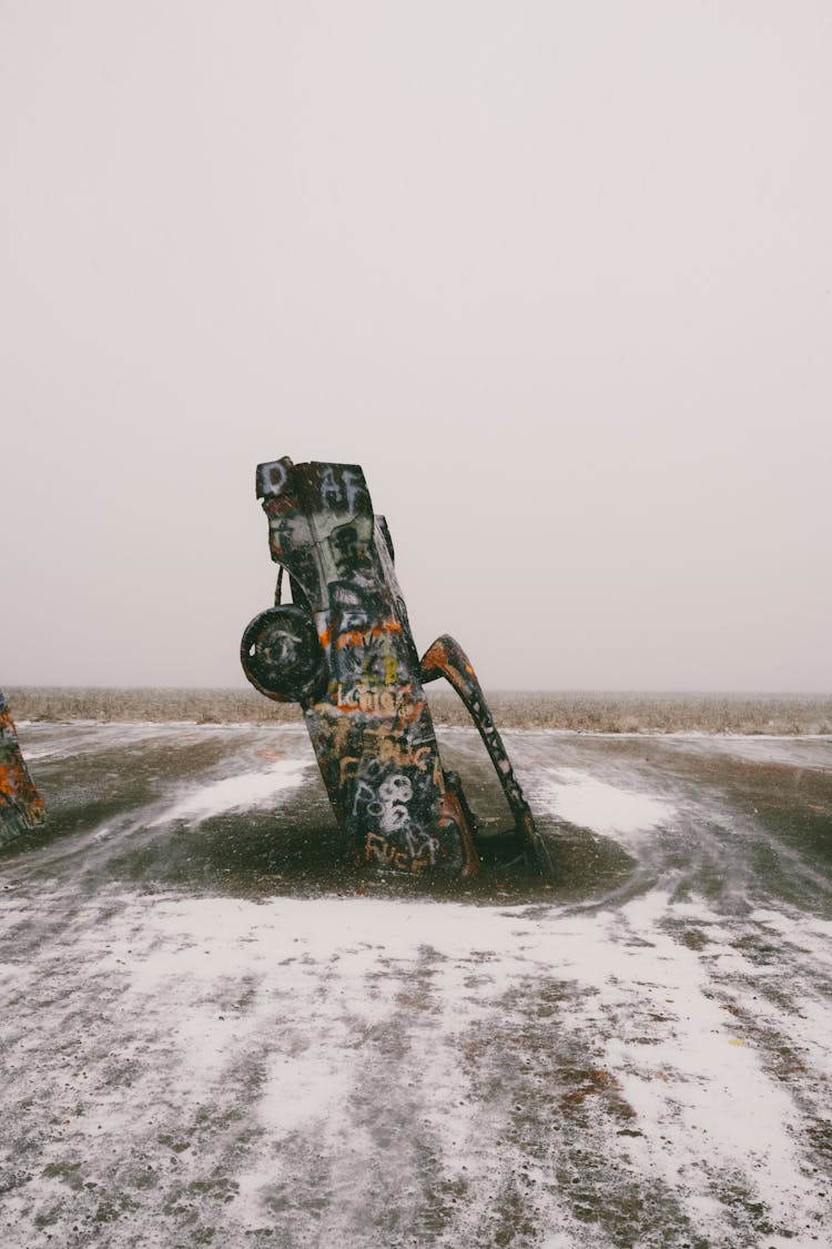 Graffiti Covered Car Wreck Stuck in Road