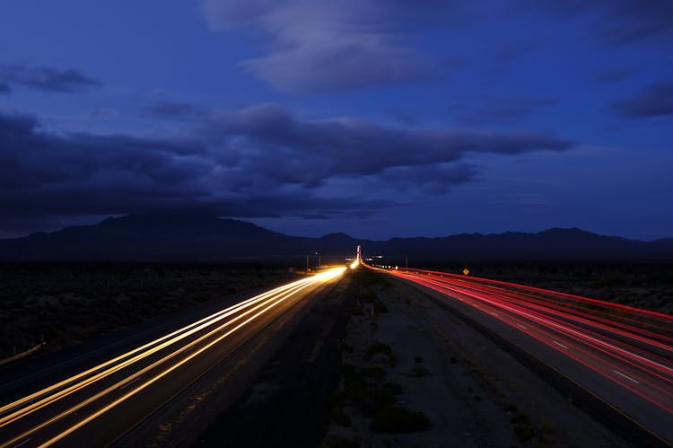 Lights On Highway At Sunset