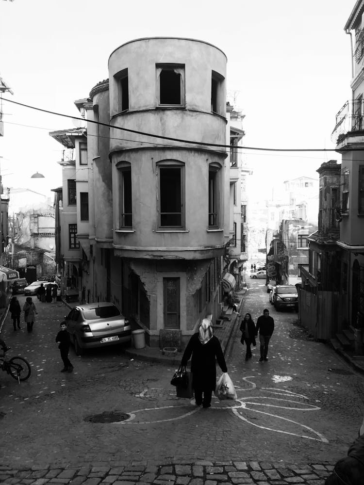 Black And White Image Of A Street With A Round Building Corner