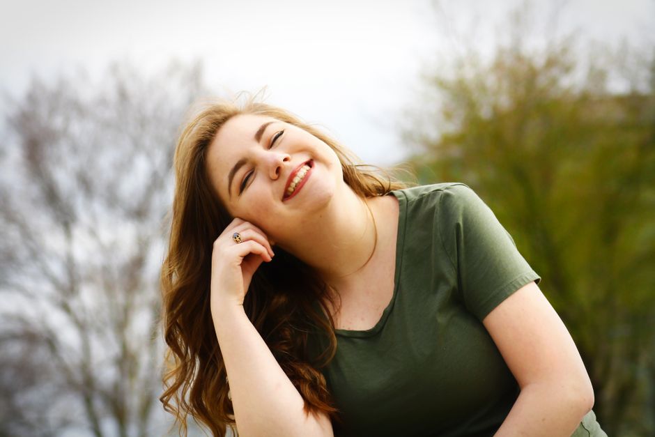 Client Claire Donovan smiling outdoors in a green t-shirt