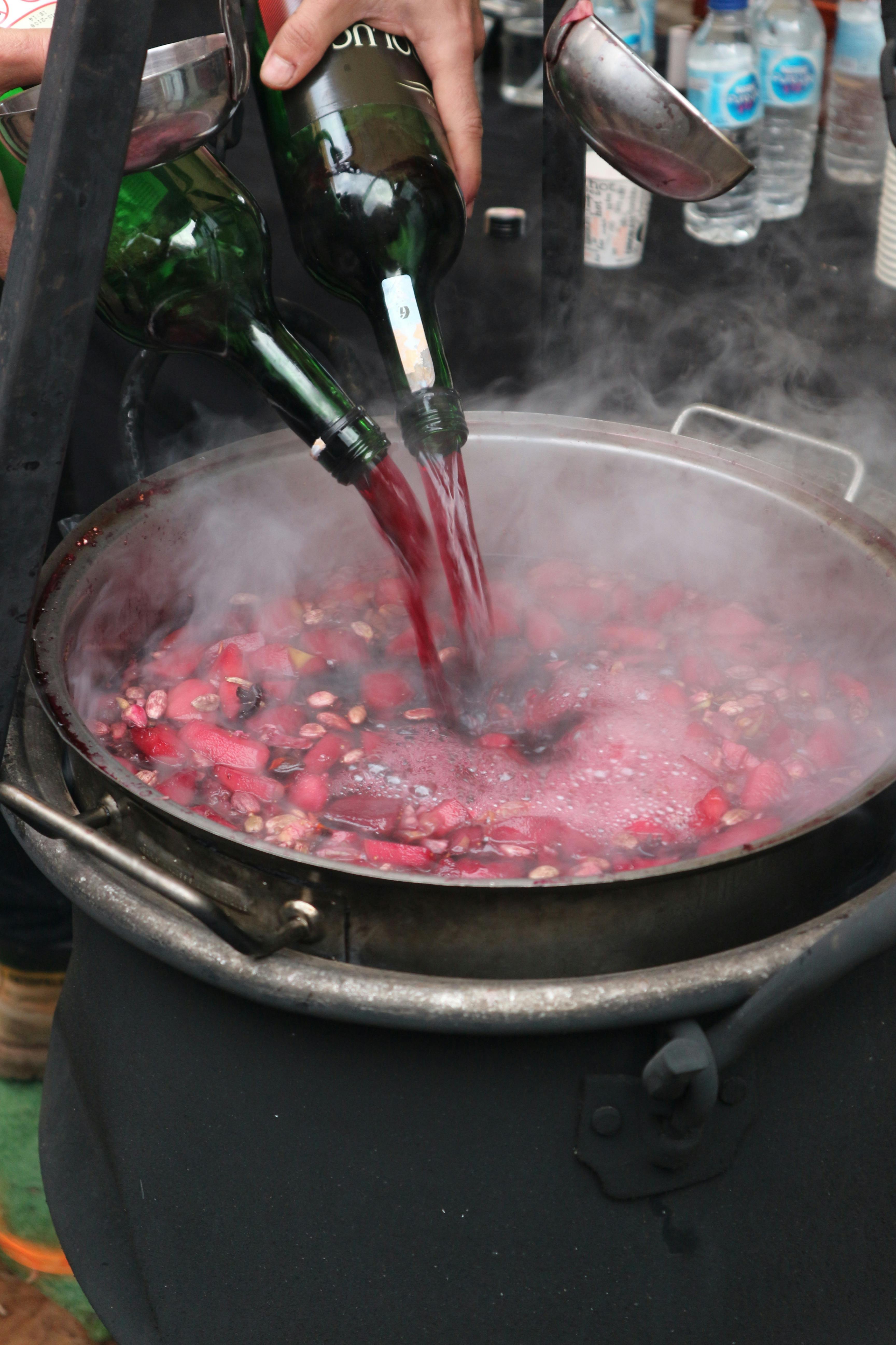 A Person Pouring Wine on a Cooking Pot · Free Stock Photo