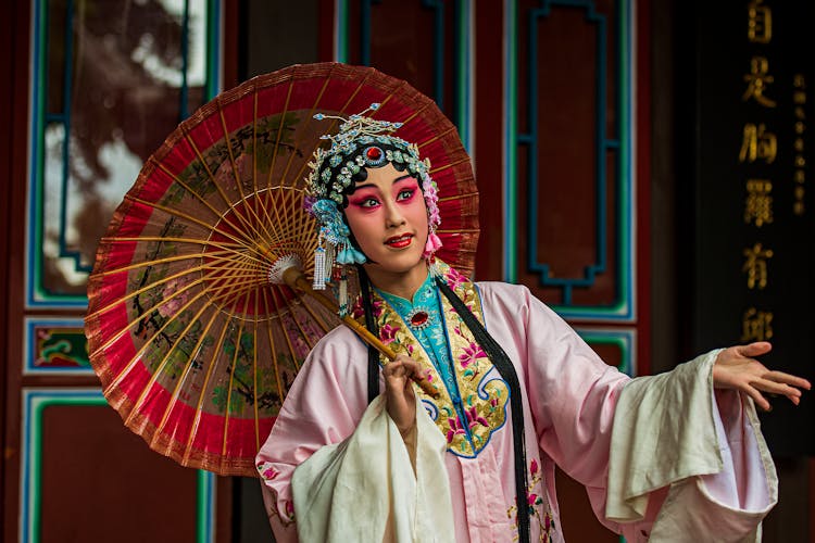 Woman In Traditional Dress And Umbrella