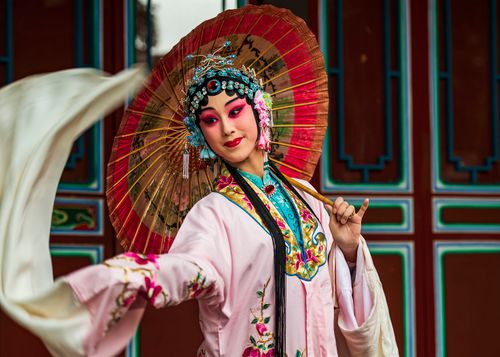 Free Woman in traditional Chinese opera costume with parasol, captured in vivid colors, New Taipei City, Taiwan. Stock Photo