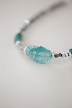 Close-up of an elegant gemstone bracelet featuring blue and silver beads.