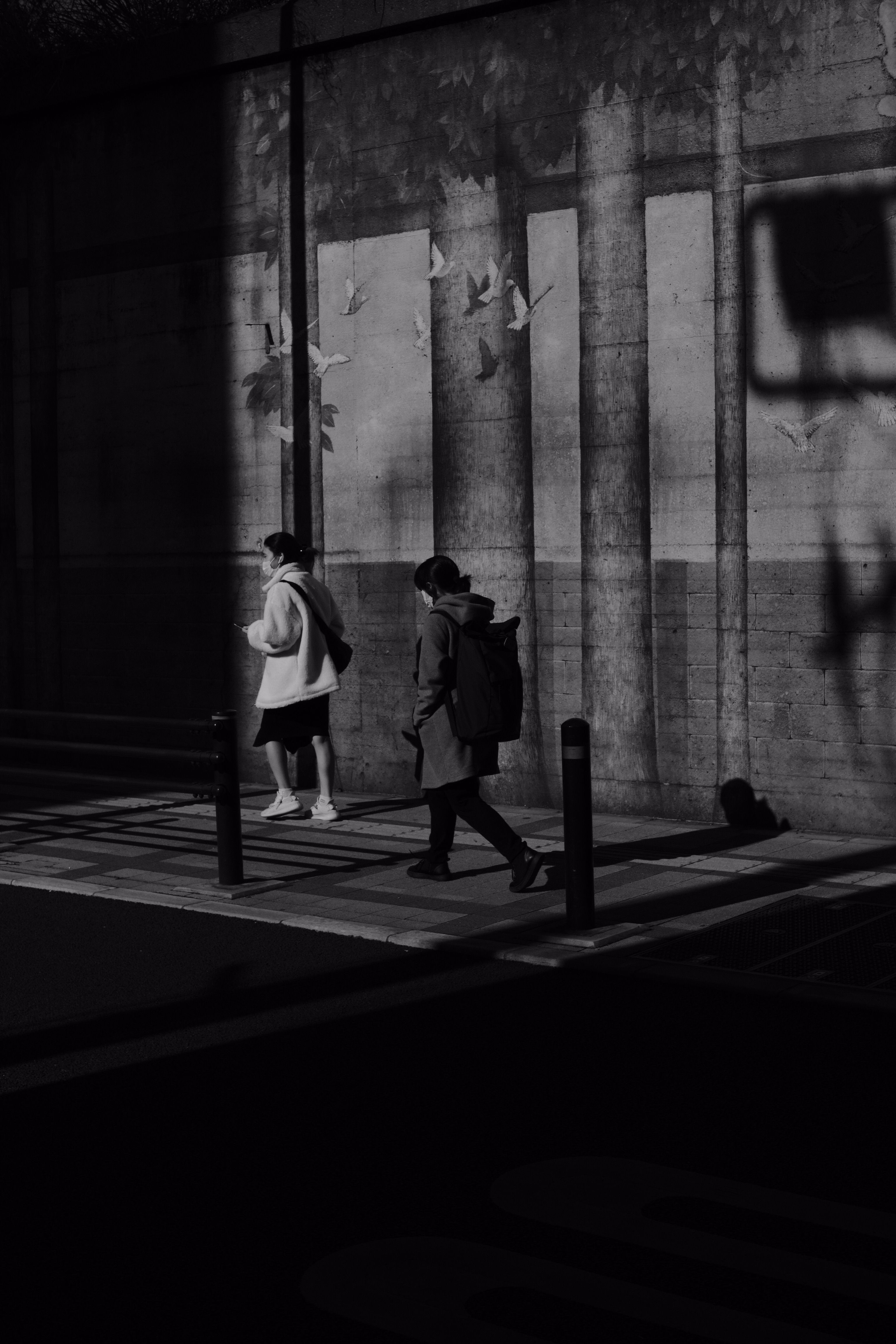 Grayscale Photo of Women Walking on Sidewalk · Free Stock Photo