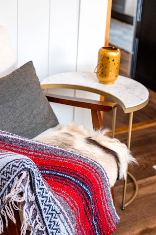 Cozy armchair with blankets forming a small reading corner