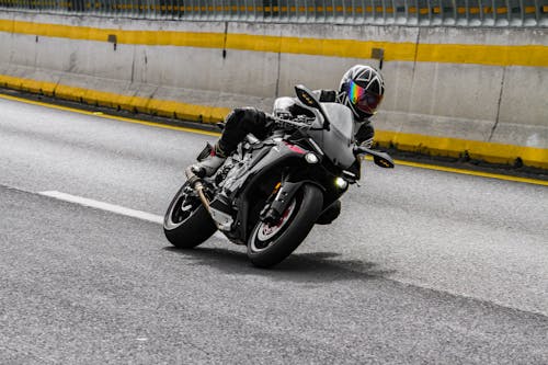 A Person Wearing a Helmet while Riding a Motorbike