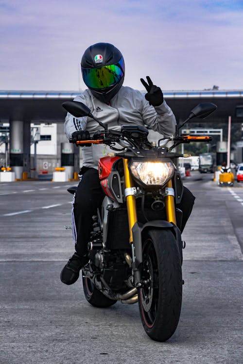 Free Man in Black Helmet Riding a Motorcycle Stock Photo