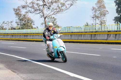 Elderly Man Riding a Scooter