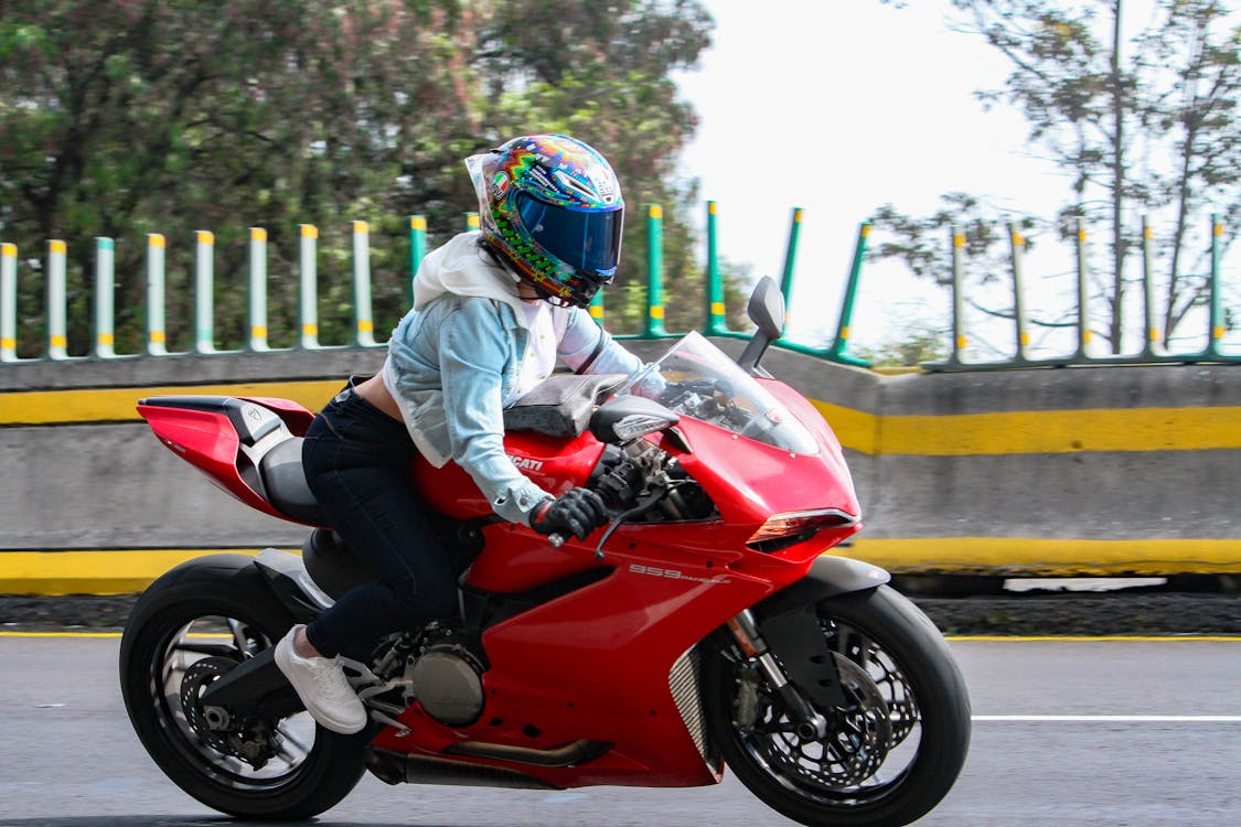 Woman Riding a Red Big Bike