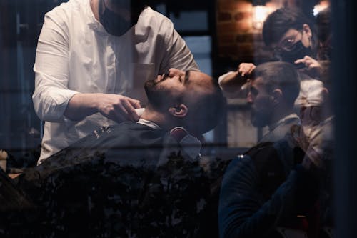 Barbers Wearing Face Masks Shaving Customers at Barbershop