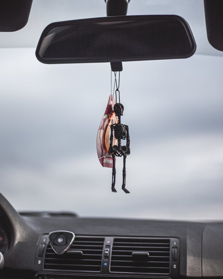 A Skeleton Keychain Inside A Car