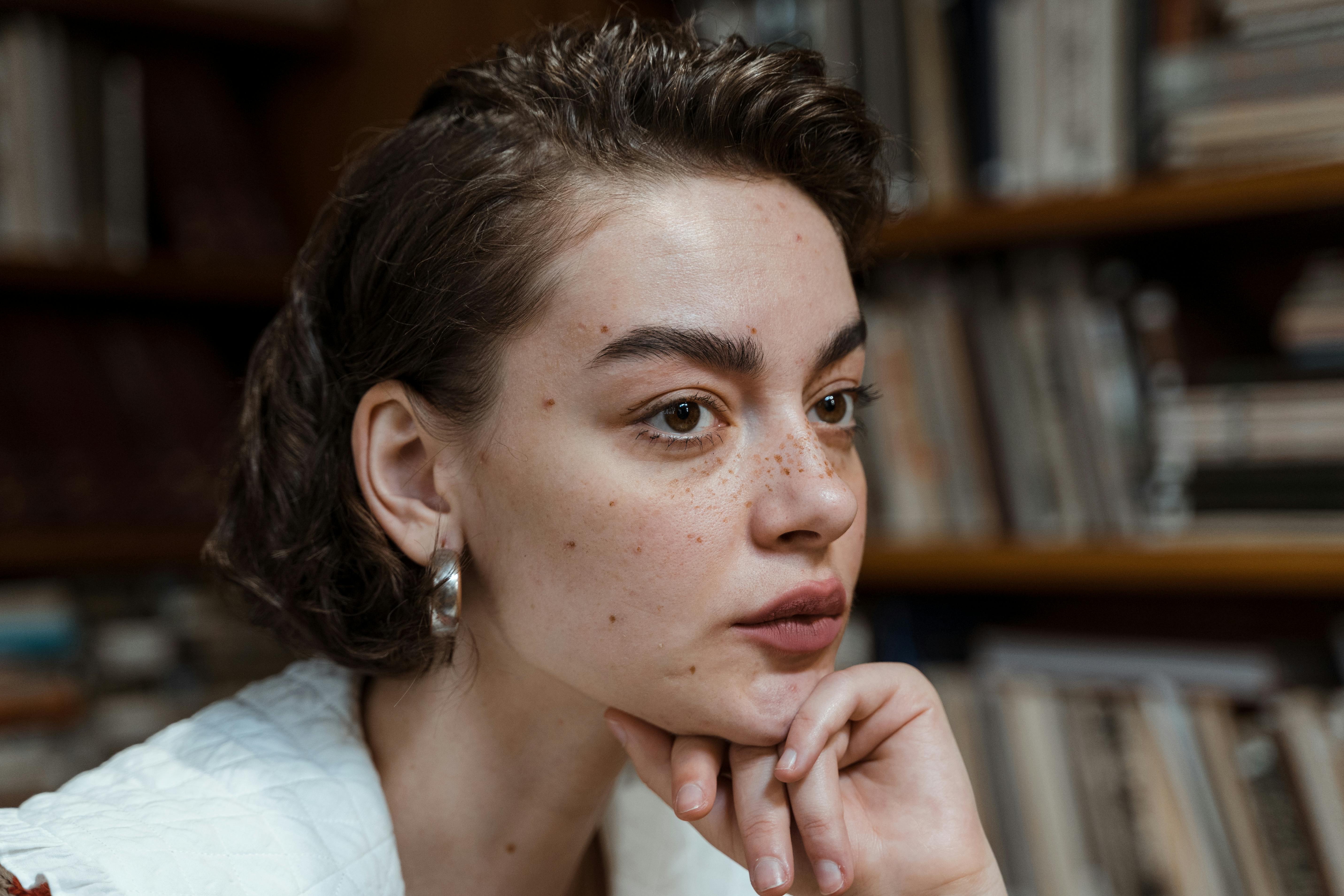 a close up shot of a woman with freckles on her face