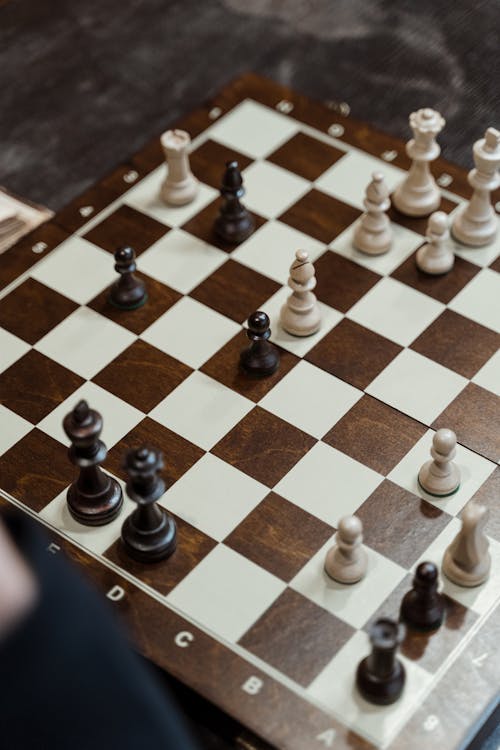 A Wooden Chess Board with Chess Pieces
