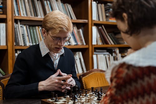 Close-up Photo of Man playing Chess 