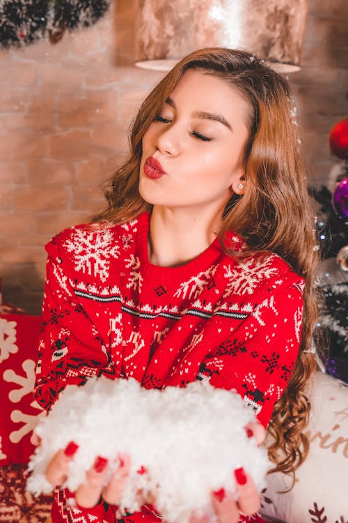 Woman in Red Sweater doing a Kiss Gesture 
