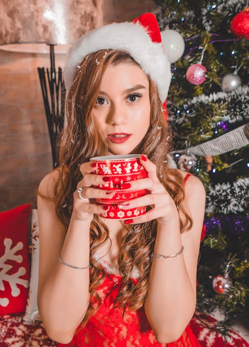 Beautiful Woman holding a Red Ceramic Cup 