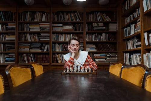 Free Pensive Woman playing Chess Stock Photo