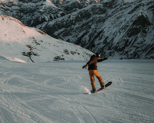 Photo of a Man Snowboarding