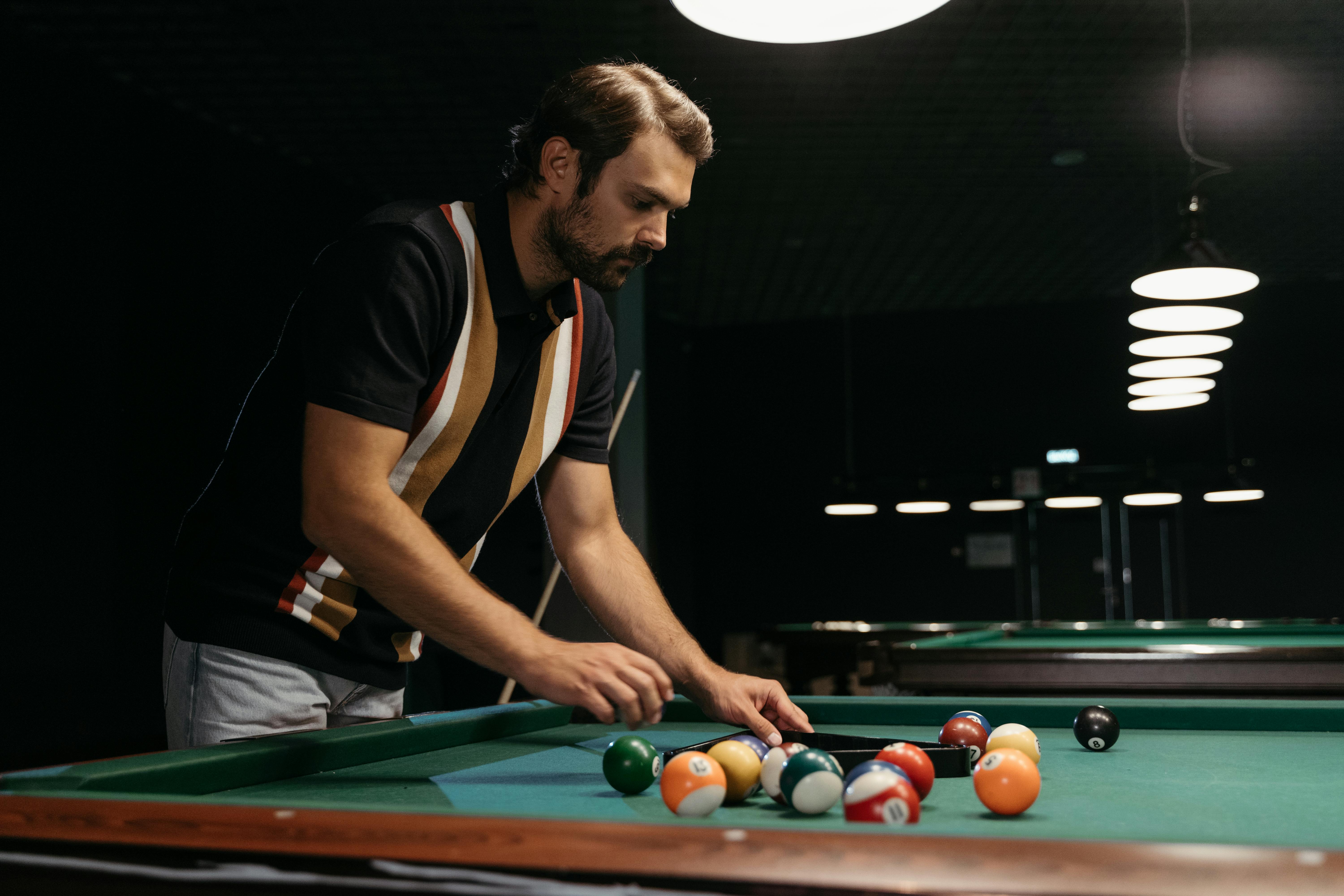 Male Player fixing the Billiard Balls · Free Stock Photo