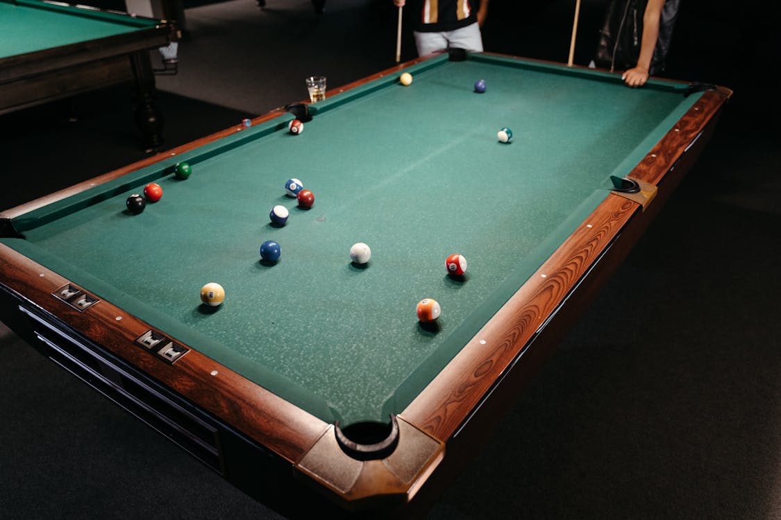 High-Angle Shot of Two People Playing Billiards