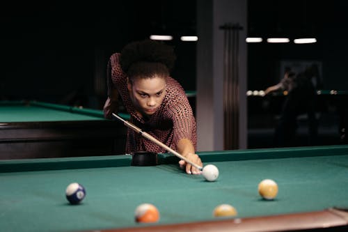 Woman Holding a Wooden Billiard Cue 