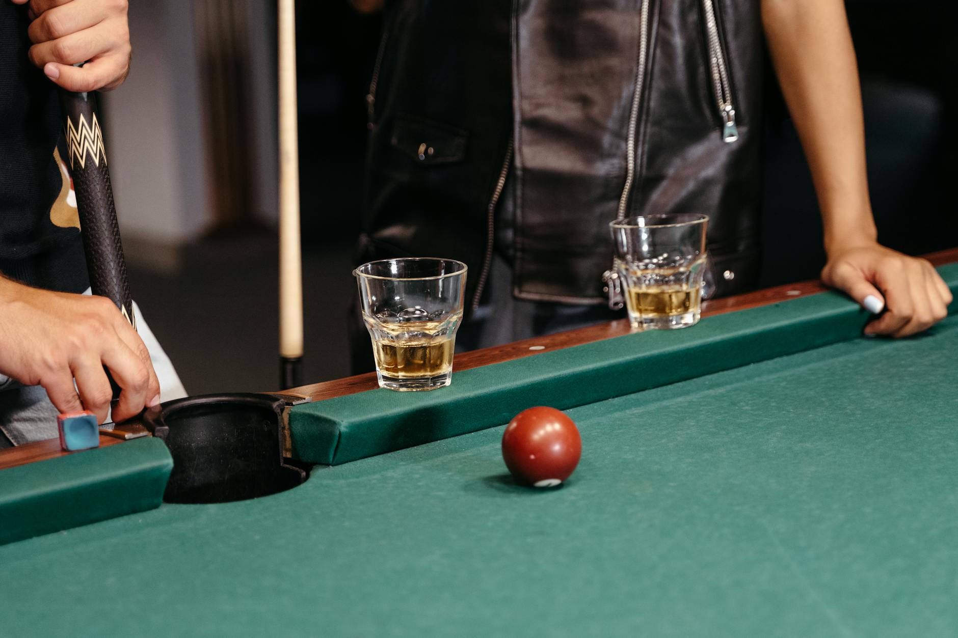 Alcohol Beverages On A Table With A Dog Looking At Them